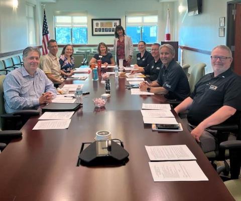 Nine PHSC staff members meeting together