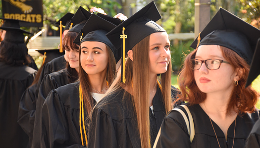 A group of PHSC graduates in their caps and gowns.