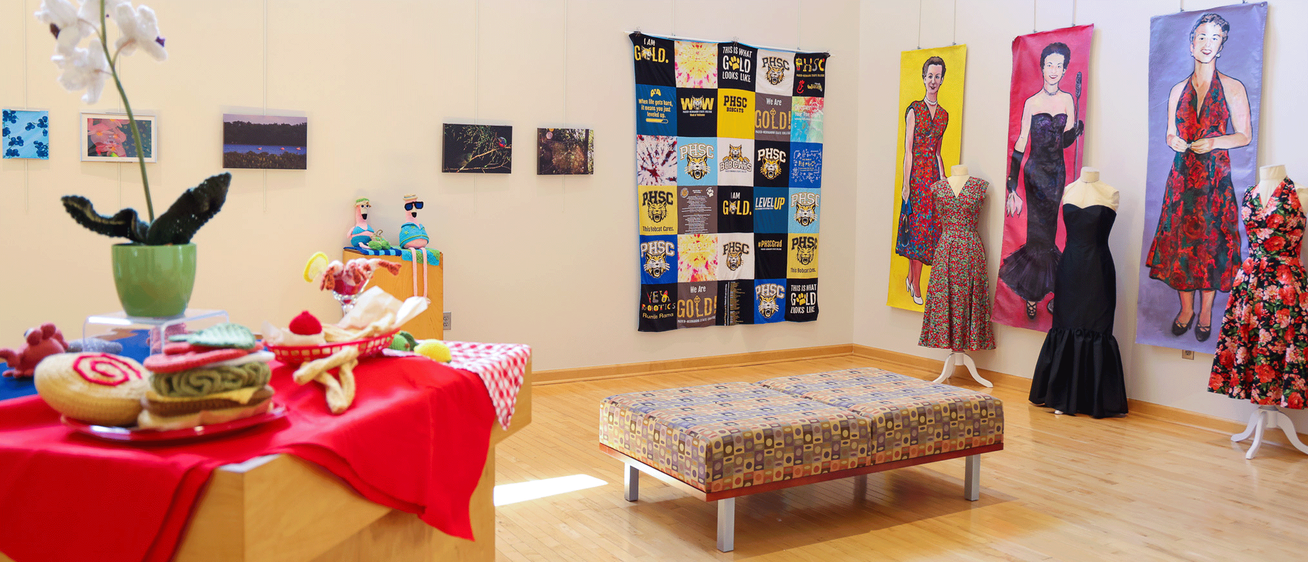 inside of the art gallery space with display of artwork hanging on the walls