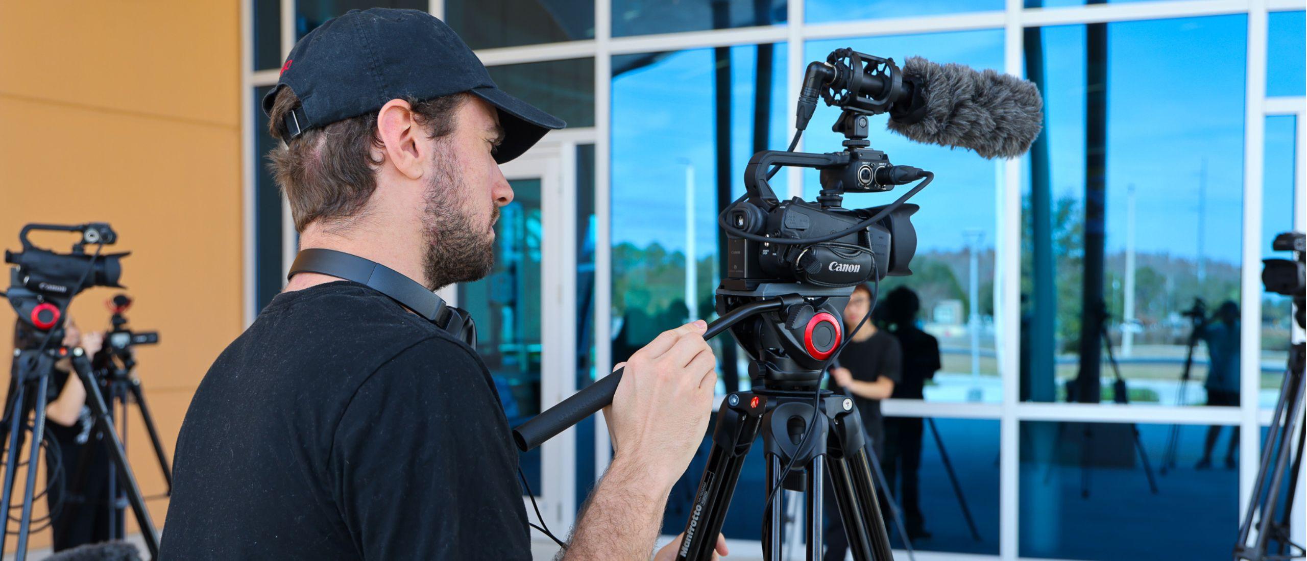 PHSC male student operating a camera