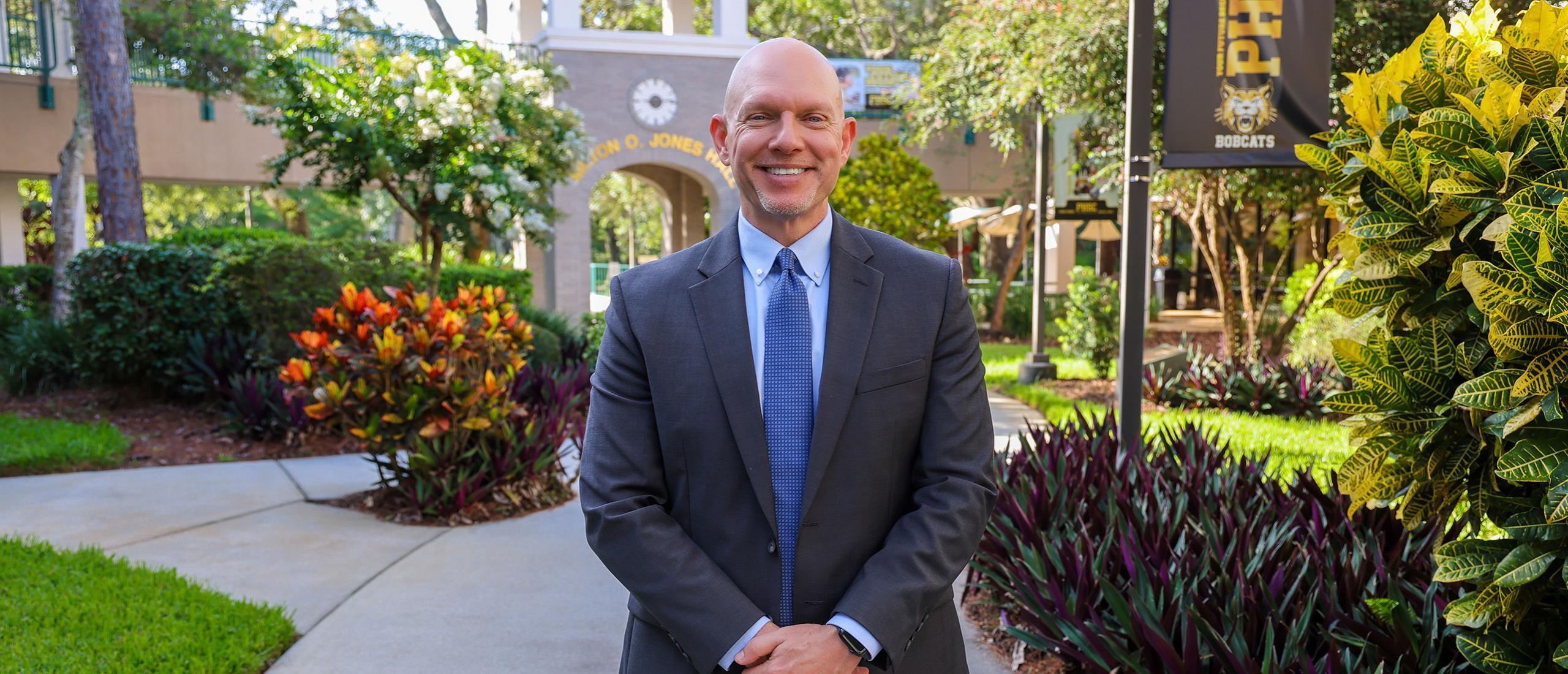 Photo of Dr. President Eric Hall at the West Campus at the Clock Tower