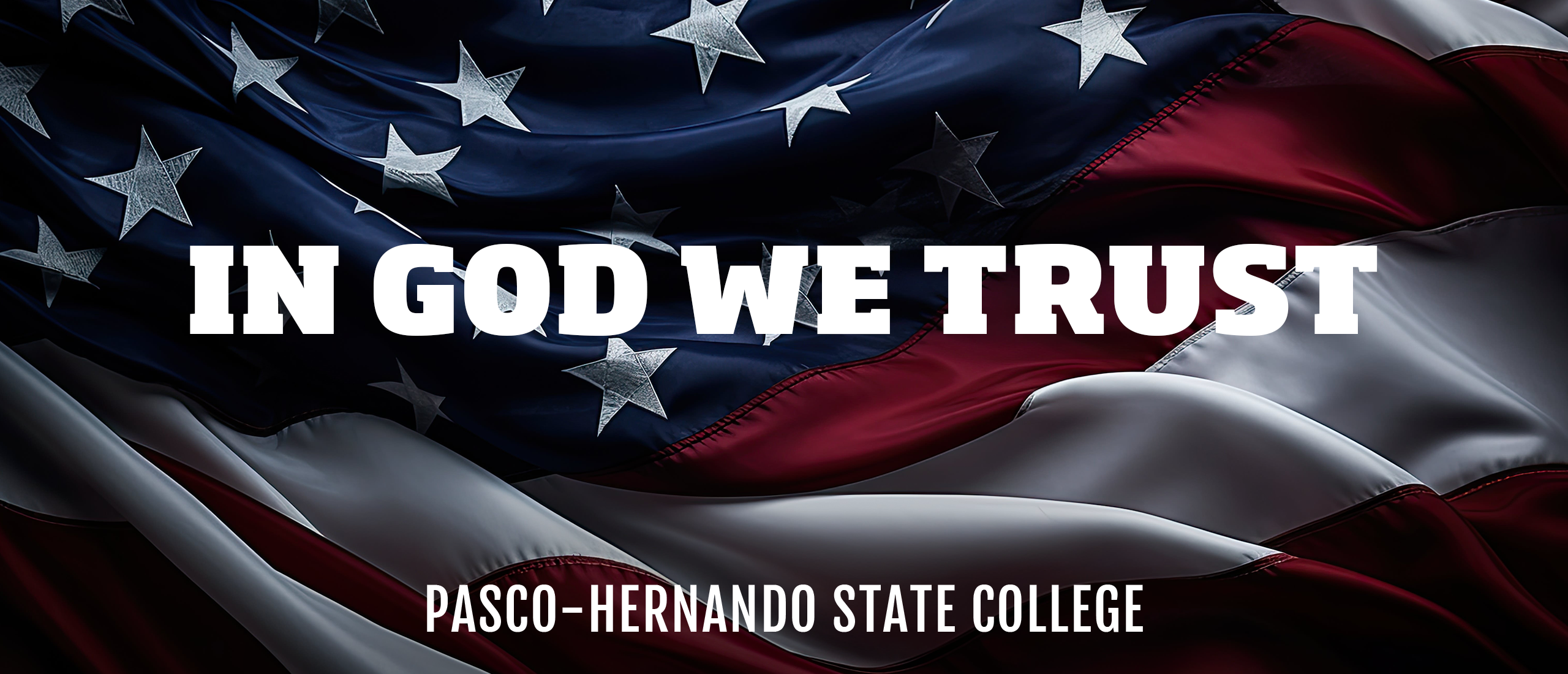 The U.S. flag with text stating "in God we trust - Pasco-Hernando State College"