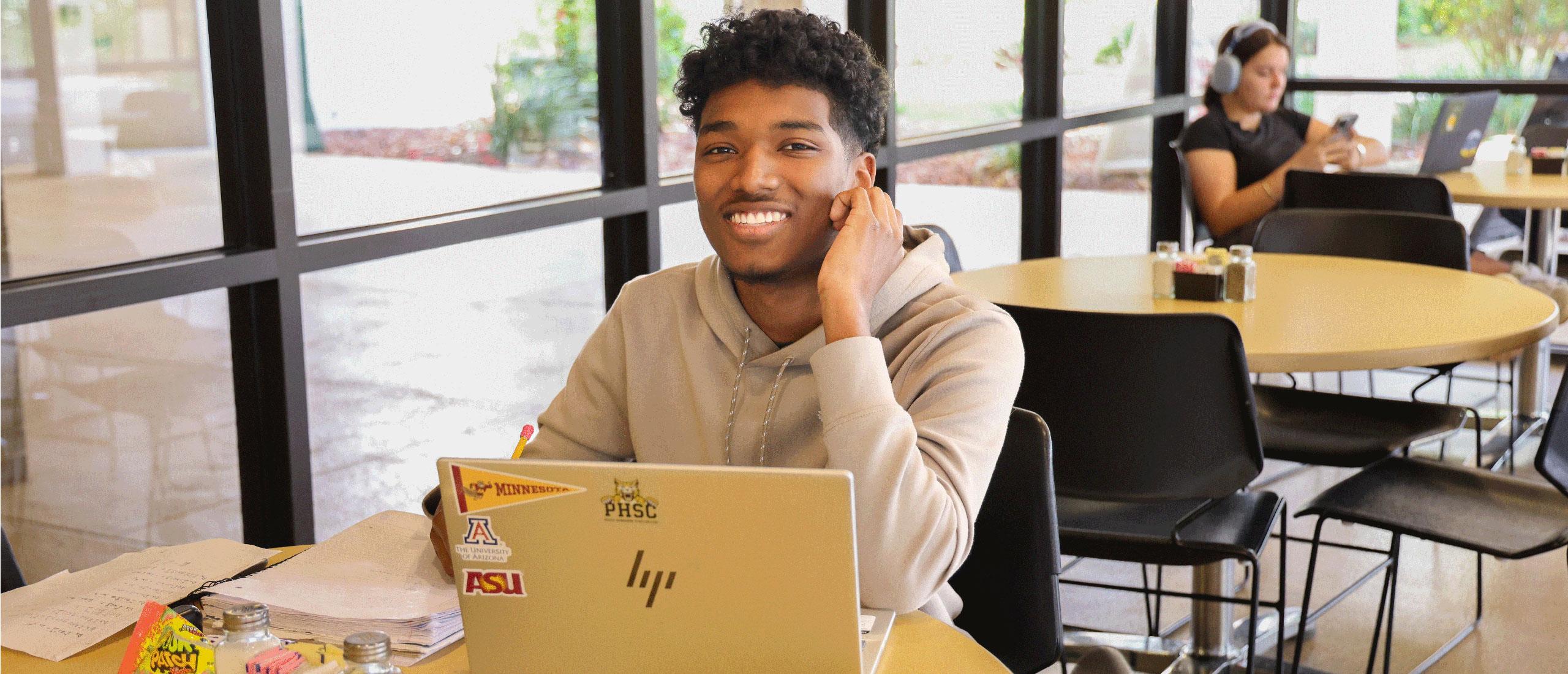 Male PHSC student studying in the Bobcat Bistro cafe.
