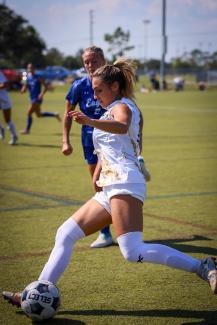 Female PHSC soccer player in action on the field