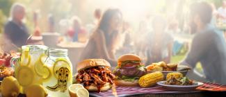 Barbeque food on a picnic table.