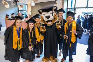 Five PHSC graduate students with the mascot Boomer.