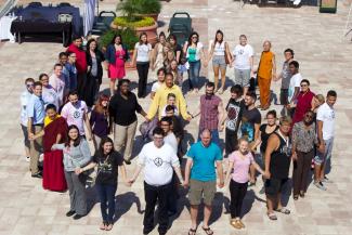 overhead image of people standing to outline shape of peace sign