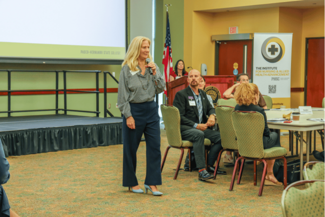 Ginnie Whitaker, director of strategic initiatives at Pasco-Hernando State College, speaks to regional healthcare leaders participating in a Nursing and Allied Health Advancement initiative