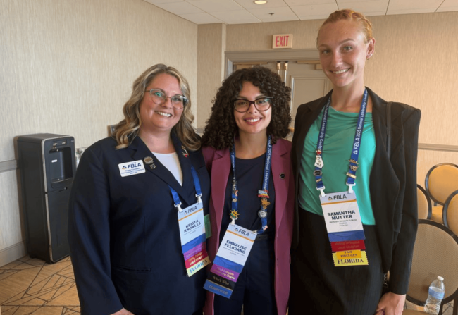 Three students posing for a group photo.