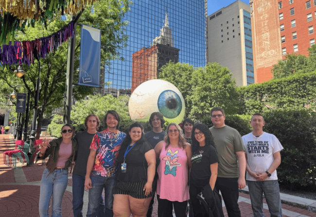 PHSC Students and Advisors hanging out in Dallas, Texas in front of a giant eye statue.