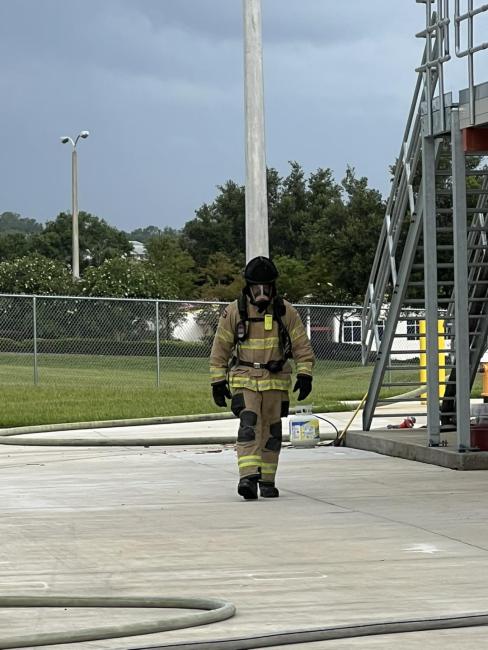 Fire Academy Cadet in full gear during training exercise.