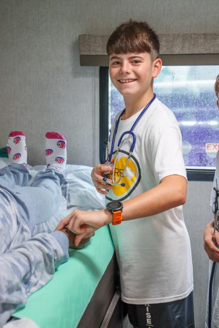 A young male camper at the Empath Health Mobile Simulation RV
