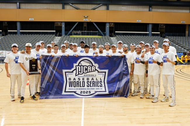 Baseball team posing with trophy at World Series Championship.