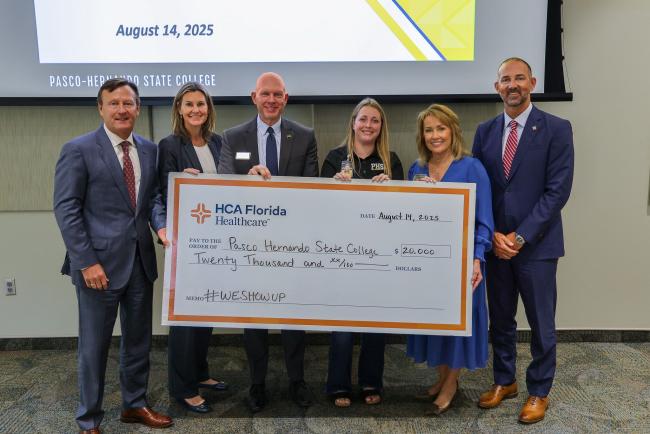 PHSC, HCA, and student together with giant check for $20,000