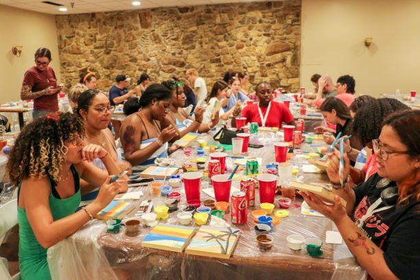 Group of students painting their canvas together